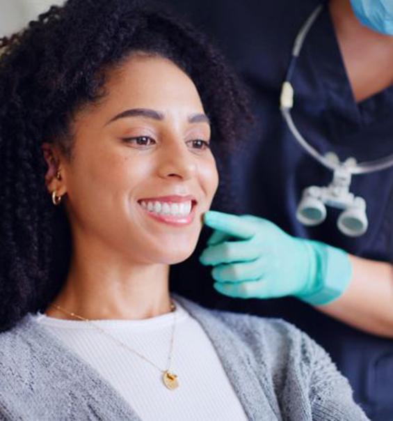 Cosmetic dentistry patient smiling at herself in mirror