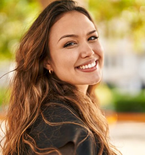 Confident, smiling woman looking over her shoulder