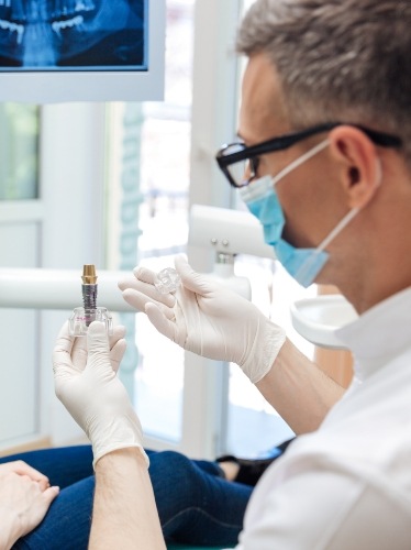member of dental staff smiling on phone