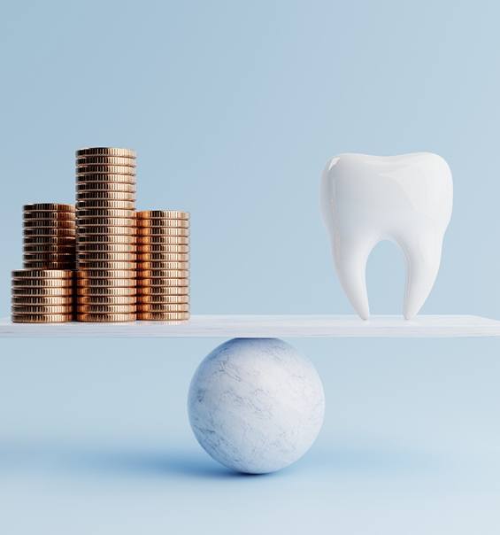 Stacks of coins and a large model tooth on a balance beam
